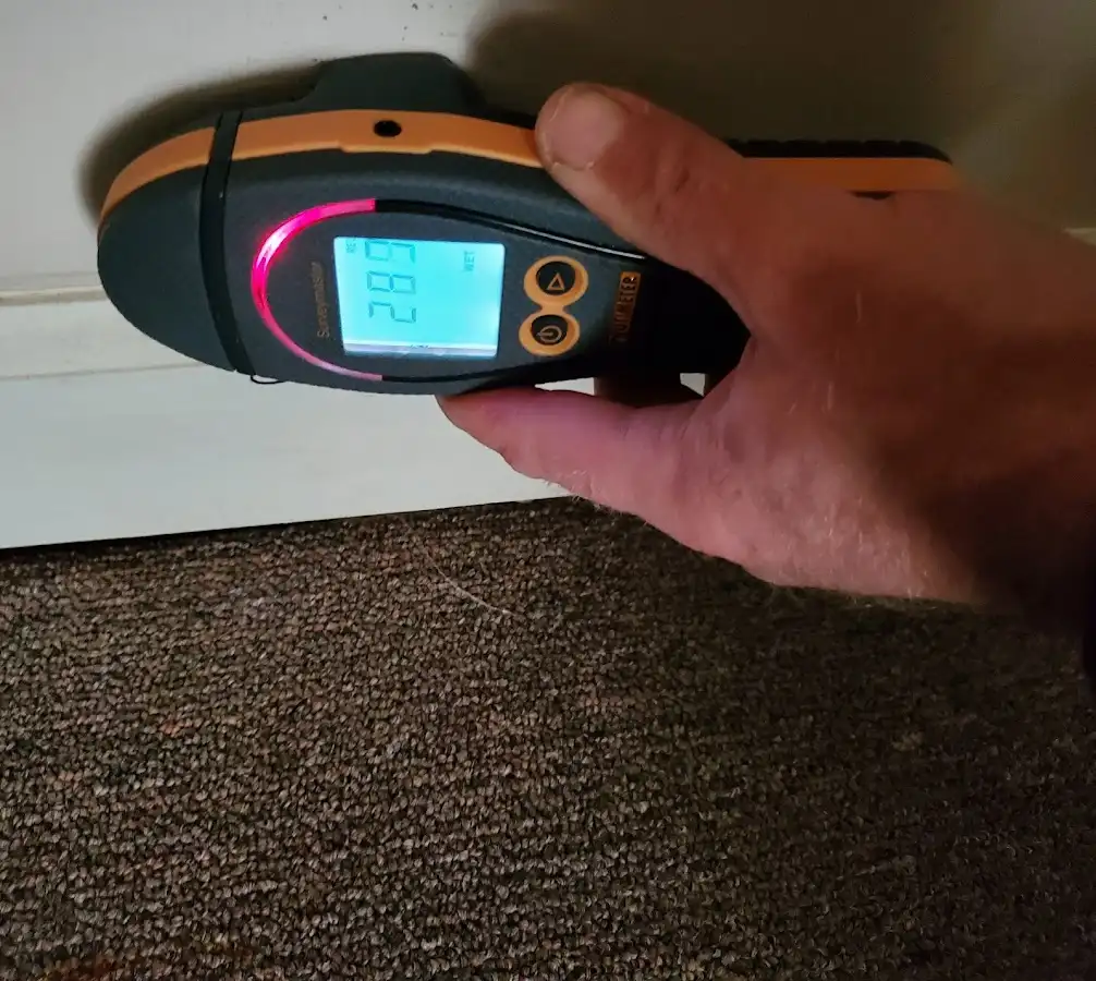 Moisture detection at baseboard during Storm Damage Restoration in Oshtemo